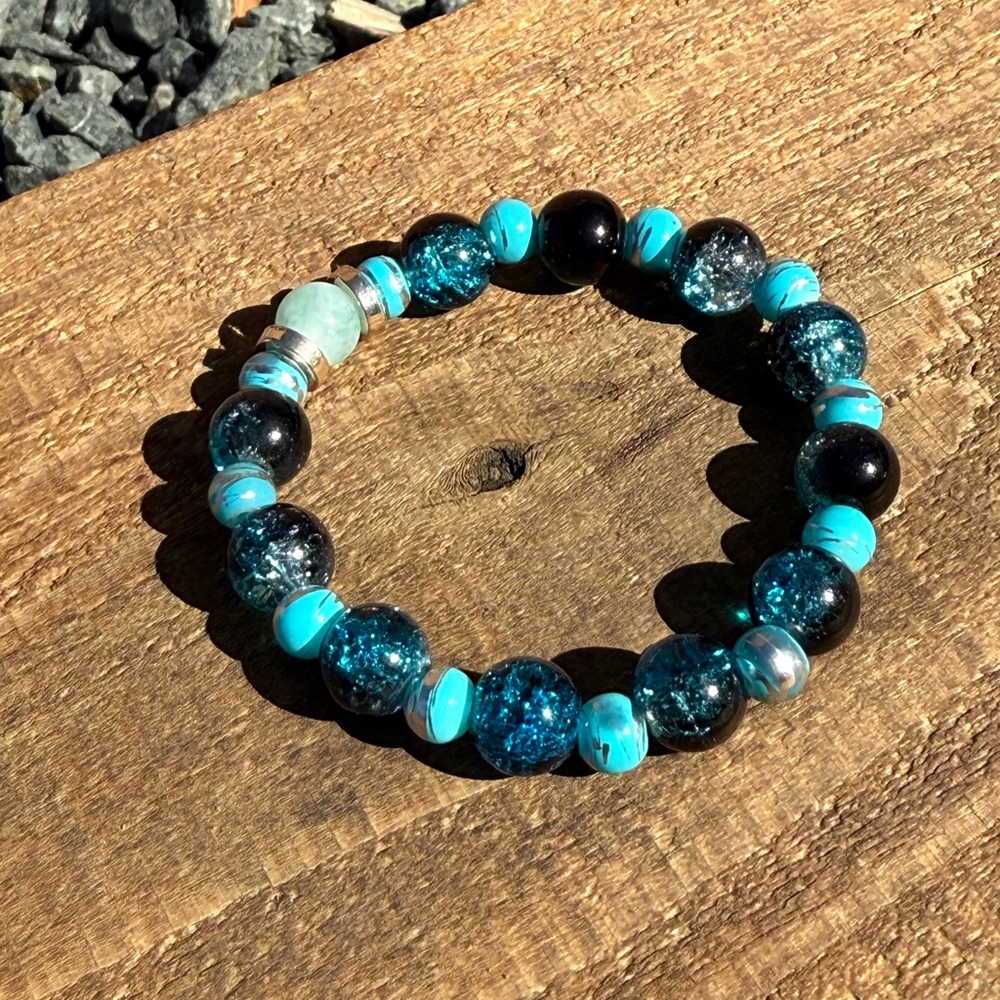 Blue sea glass and Black Beaded Bracelet with a focal bead of Green Chalcedony.